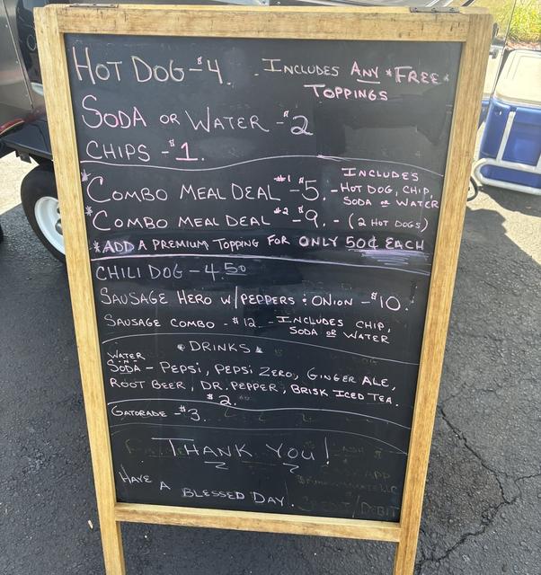 Hand-lettered chalkboard menu sign listing hot dog and combo prices